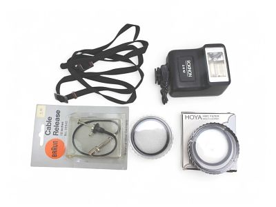 A Group of Photography Accessories. Including a Braun in inches cable release, a Pokinon 26M 