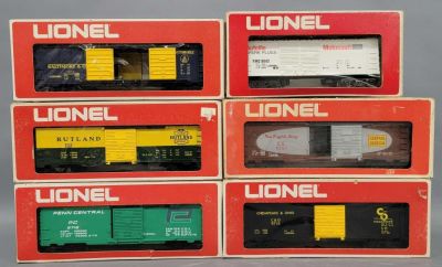 Six Lionel O gauge mixed box cars in original boxes. Includes 9042 Autolight box car, 9710 