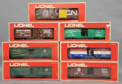 Seven Lionel O gauge mixed box cars in original boxes. Includes 9301 US Mail car, (incorrect 