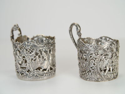 SILVER CUP HOLDERS. height: 6 cm 
800 silver 
first cup holder: 112 gr. 
second one: 98 gr. 