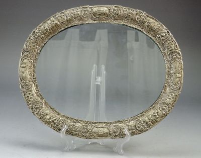A silver and glass tray. decorated with embossed rural scenes. Dimensions: 34x28 cm
