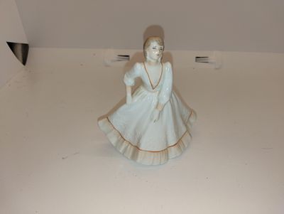 Coalport Porcelain Figurine of a Girl. Small Coalport porcelain figurine of a girl in a white