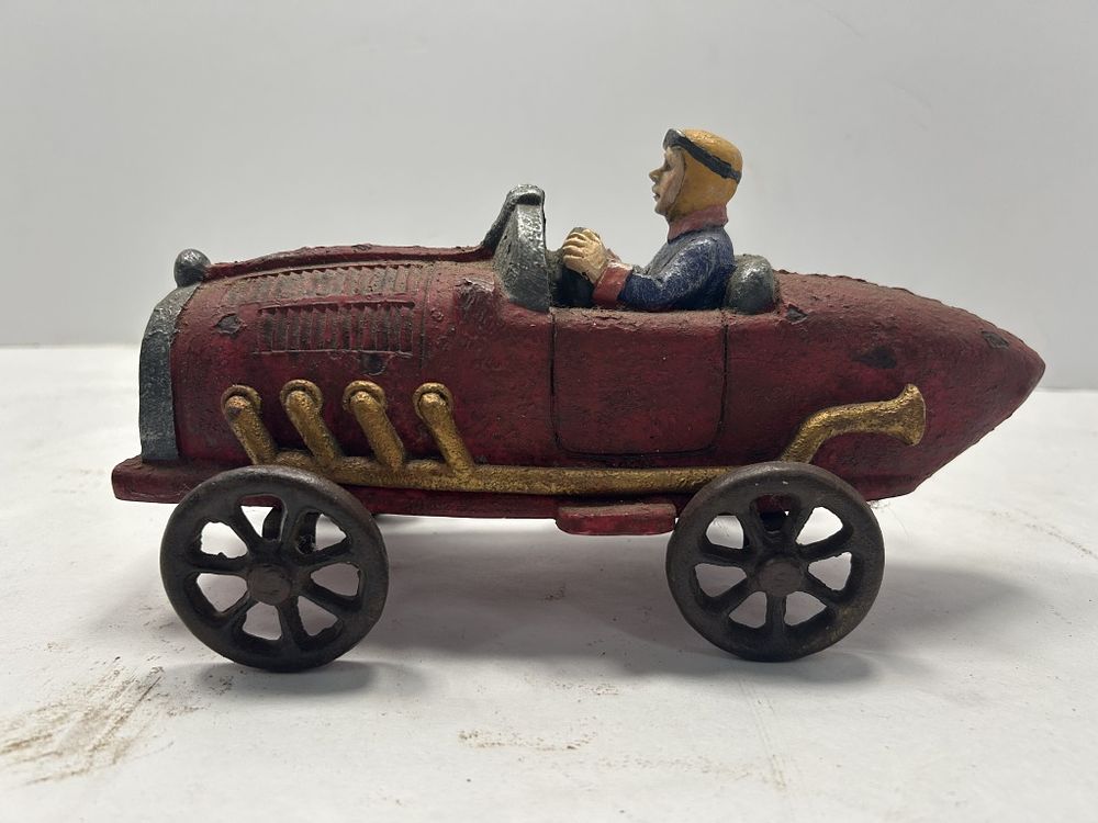 Lot 253: CAST IRON RACE CAR FIGURE