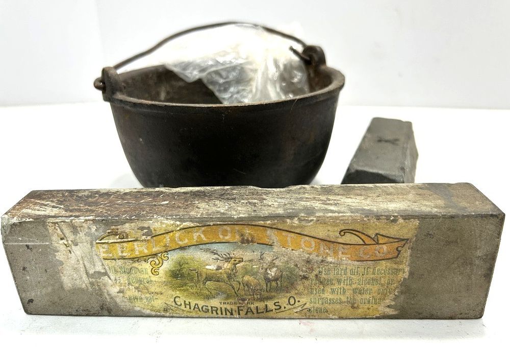 Lot 304: SHARPENING STONE, LEAD, AND CAST IRON POT