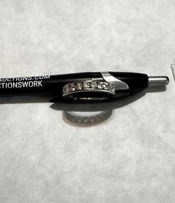 14 K WHITE GOLD CHANNEL SET BAND. 11 ROUND (MINED) DIAMONDS, CHANNEL SET BAND, 3.2 GRAMS, SIZE 10