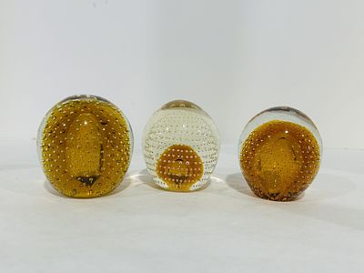 VINTAGE AMBER PAPER WEIGHTS. .