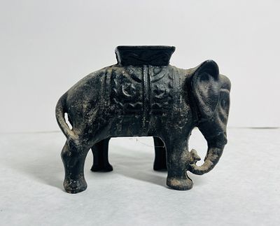 Antique Cast Iron Elephant with Howdah Still Bank. An antique cast iron still bank modeled in 