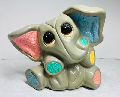 Painted Ceramic Baby Elephant Figurine, 1981. A whimsical ceramic figurine of a baby elephant 