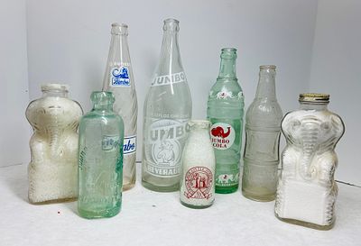 Vintage Elephant-Themed Glass Beverage Bottles. A collection of vintage glass beverage bottles 