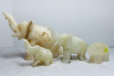 Carved Banded Onyx Elephant Figurines. A group of decorative elephant figurines hand-carved from 