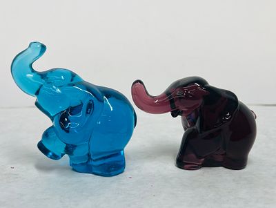 Glass Elephant Figurines in Blue and Amethyst. This lot comprises two molded glass elephant 