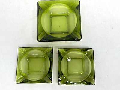 ANCHOR HOCKING STYLE GREEN GLASS ASHTRAYS. A trio of avocado green pressed glass ashtrays 