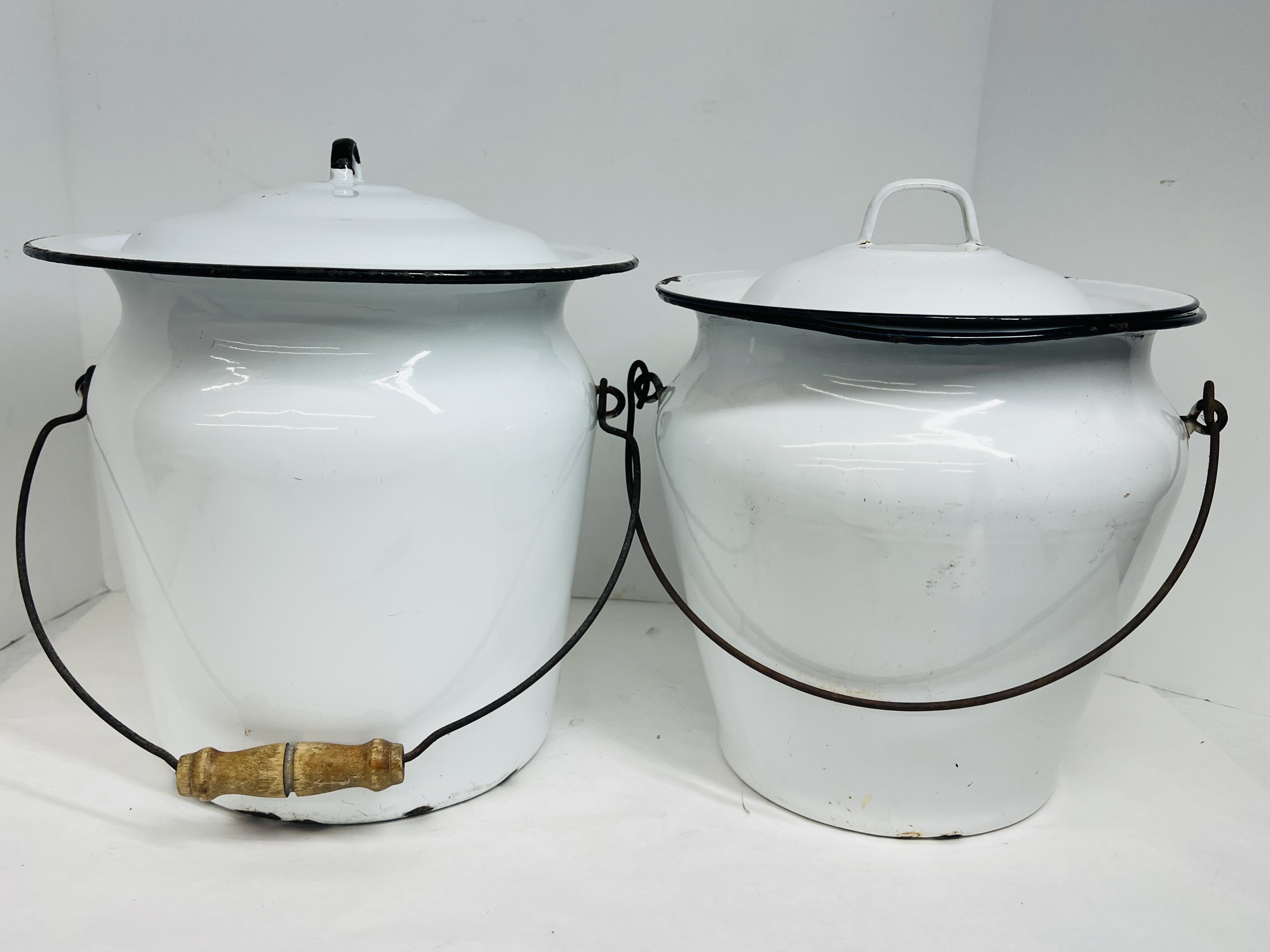 TWO WHITE ENAMELWARE CHAMBER BUCKETS, CIRCA 1900
