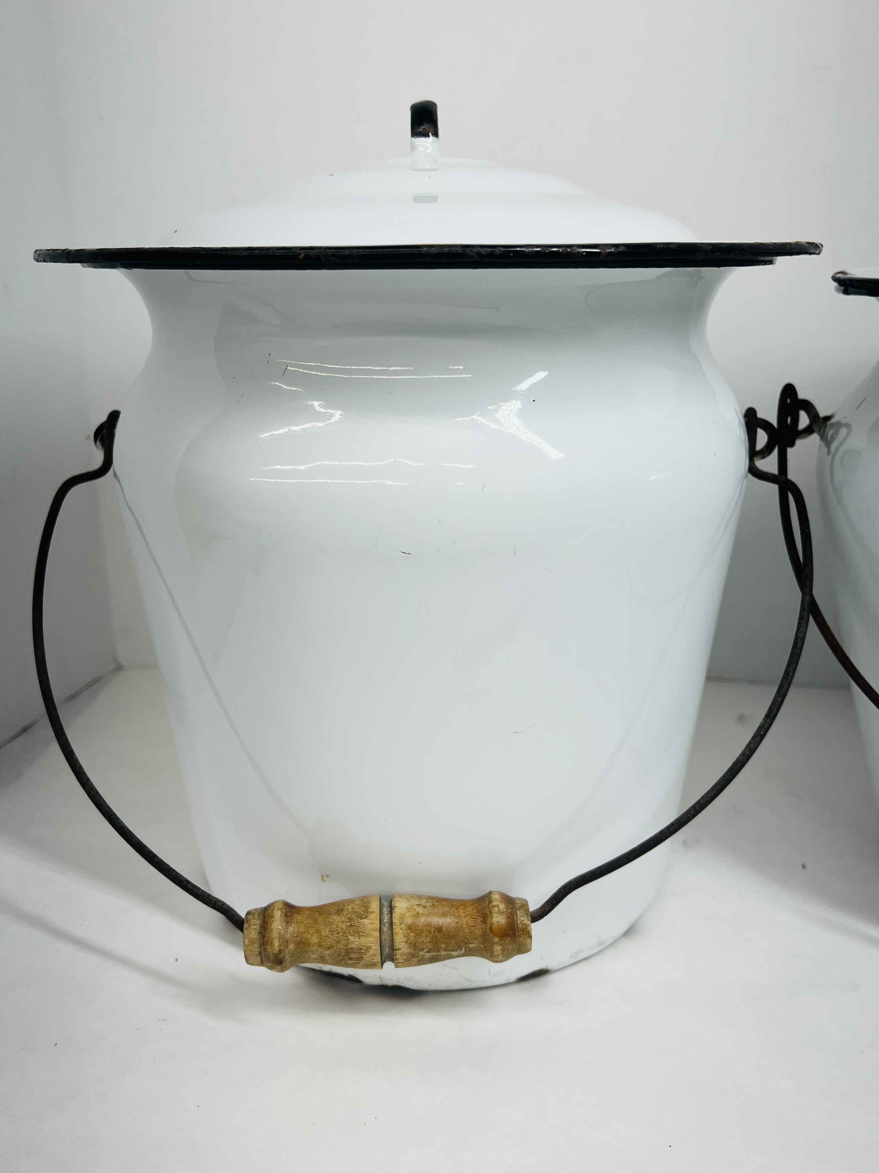 TWO WHITE ENAMELWARE CHAMBER BUCKETS, CIRCA 1900