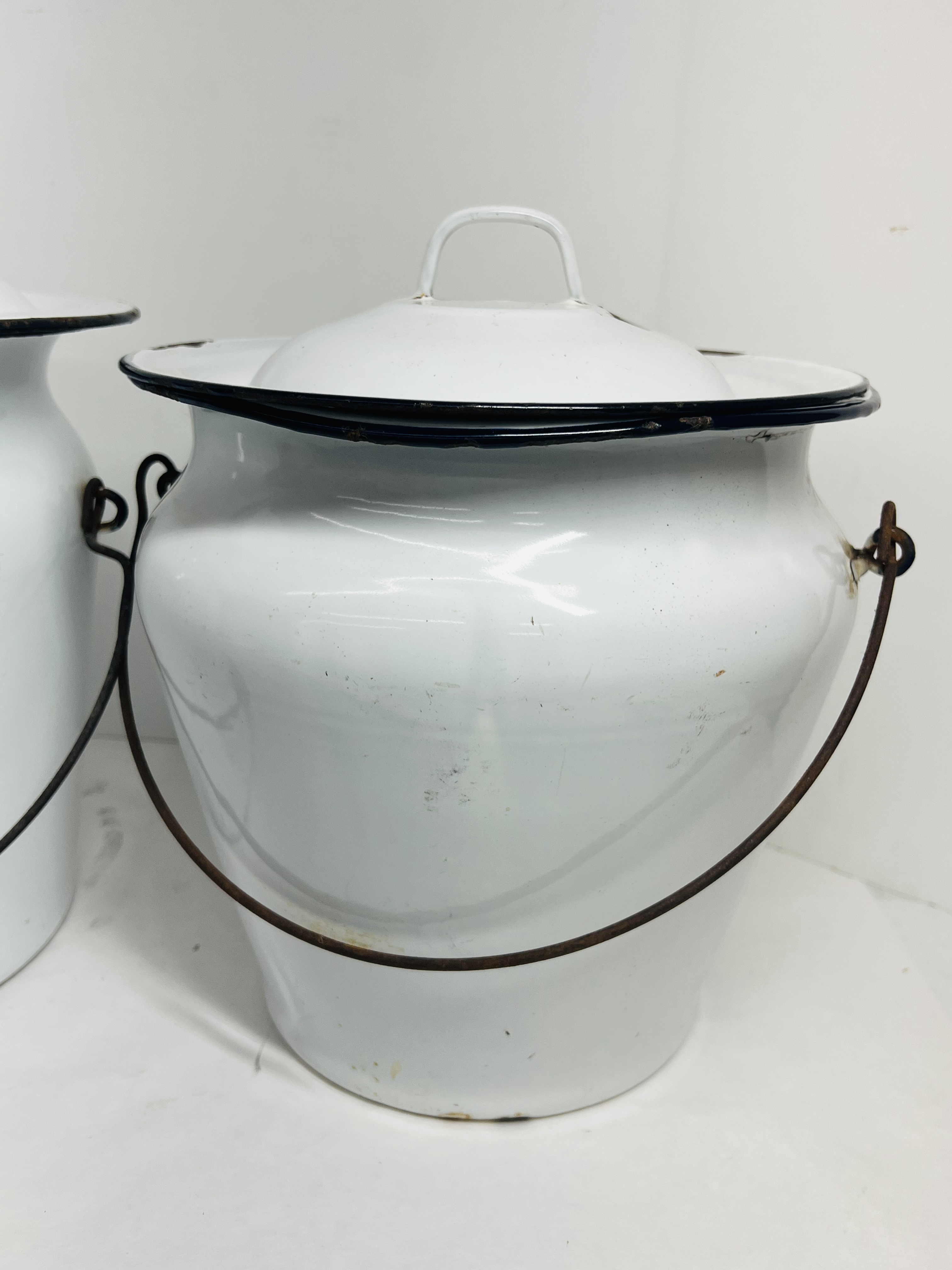 TWO WHITE ENAMELWARE CHAMBER BUCKETS, CIRCA 1900