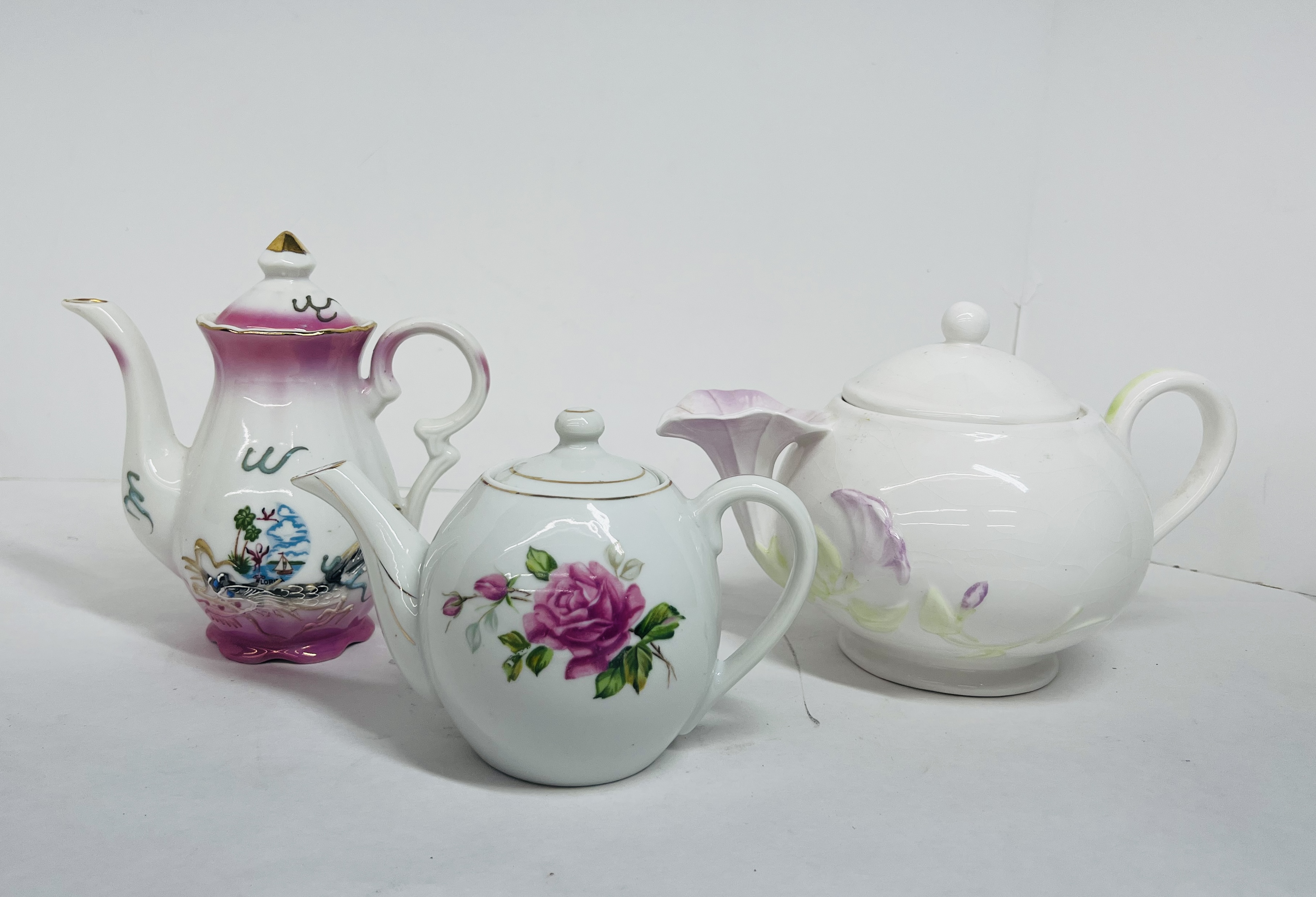 TRIO OF VINTAGE PORCELAIN TEAPOTS
