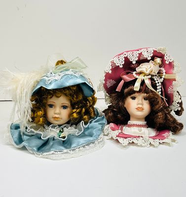 DANDEE PAIR PORCELAIN DOLL BUSTS 1990S. A pair of porcelain bisque doll busts from The 