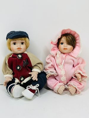 PAIR OF THEMED BISQUE DOLLS. A pair of dolls featuring bisque porcelain heads and limbs with 