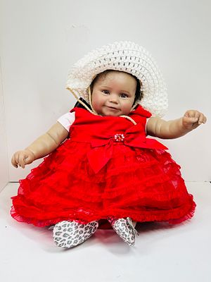 REBORN TODDLER DOLL IN RED DRESS. Life-like reborn toddler doll featuring hand-rooted dark hair 