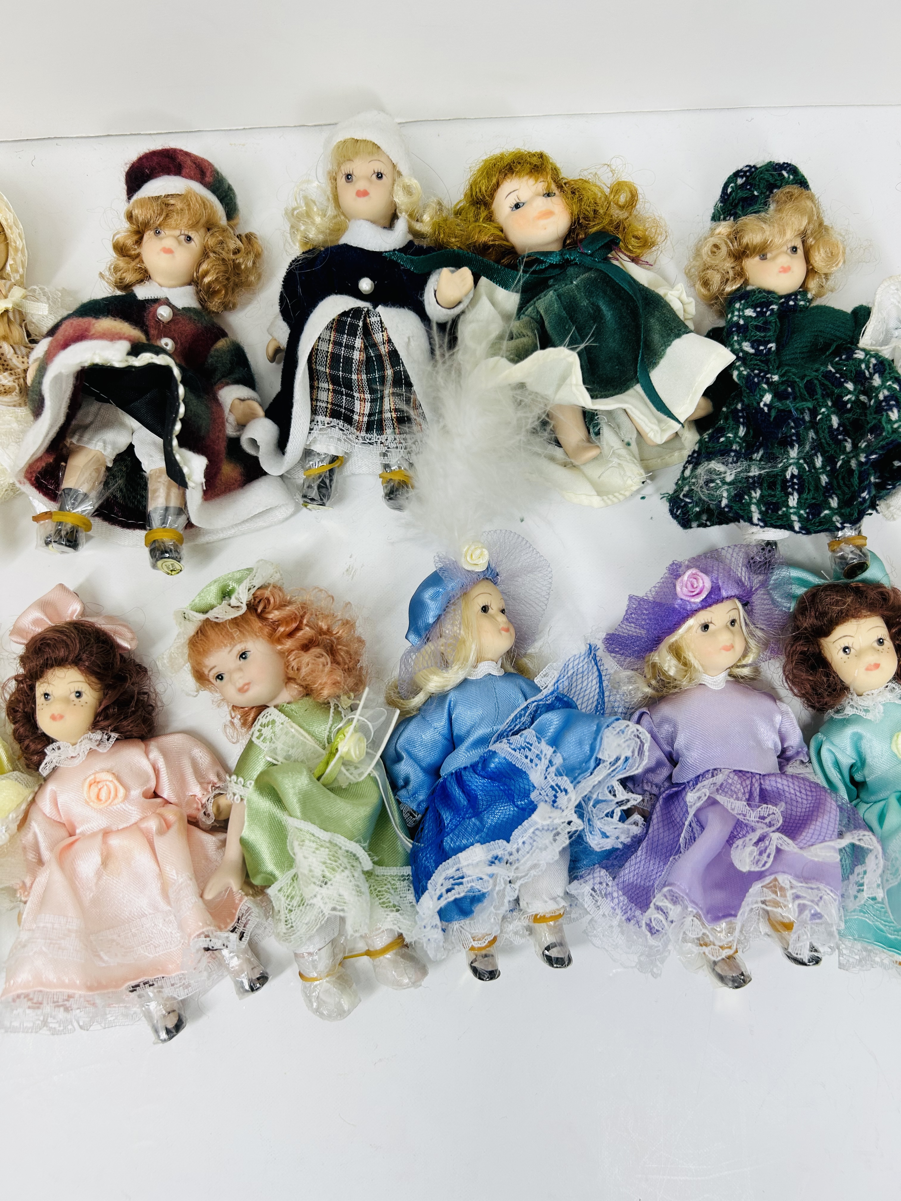 SEVENTEEN PORCELAIN COLLECTOR DOLLS, CIRCA 1990