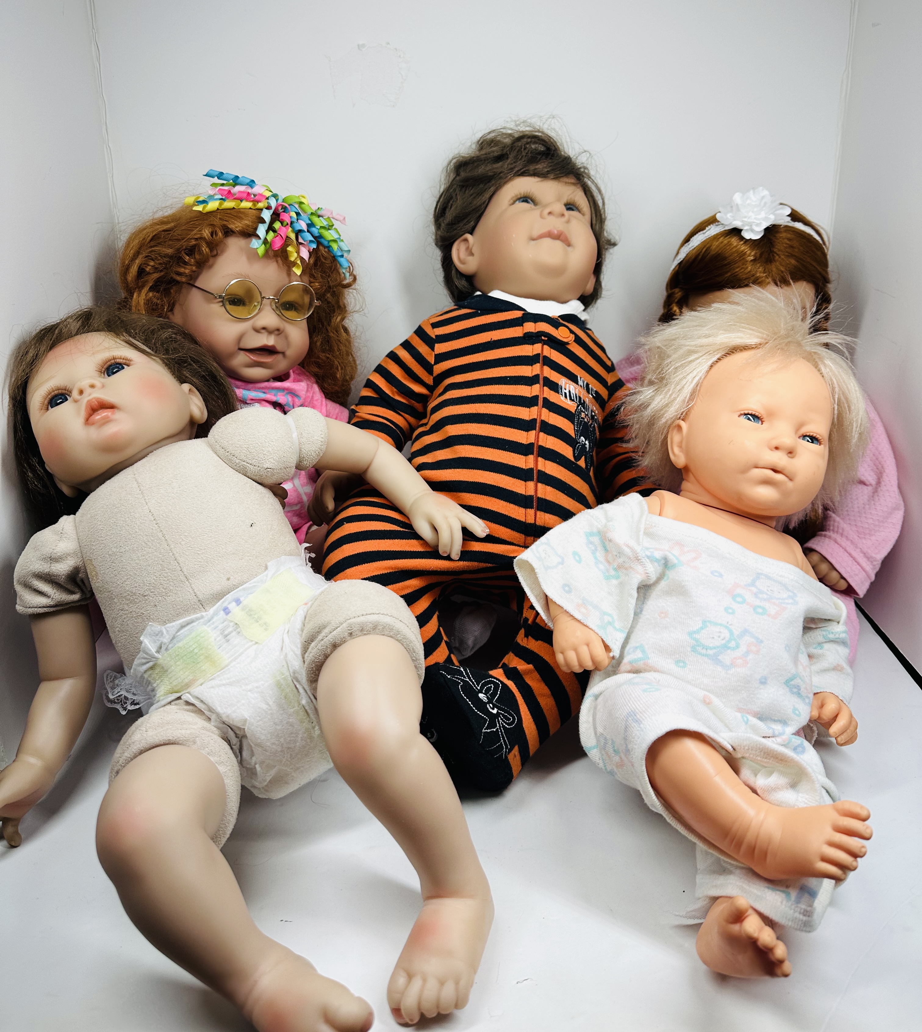 FIVE COLLECTIBLE VINYL AND CLOTH DOLLS