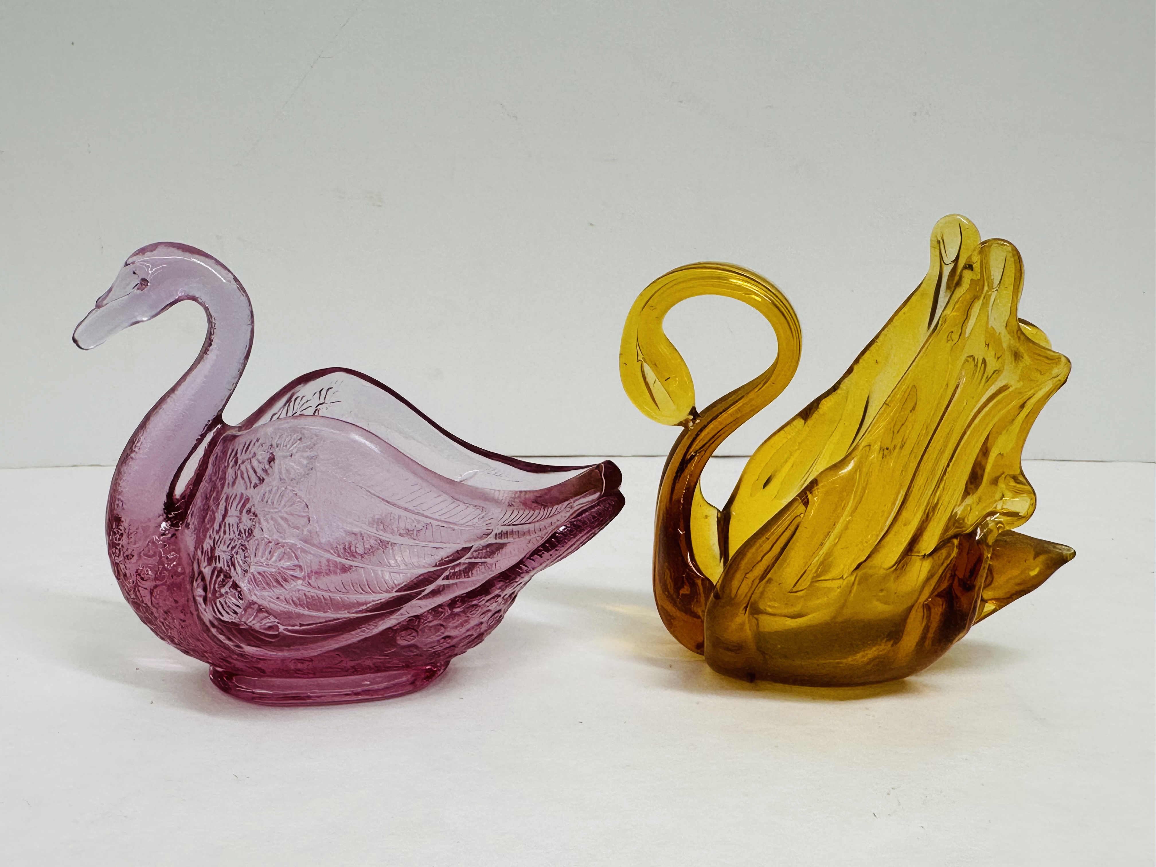 FENTON AND AMBER GLASS SWANS, 1999