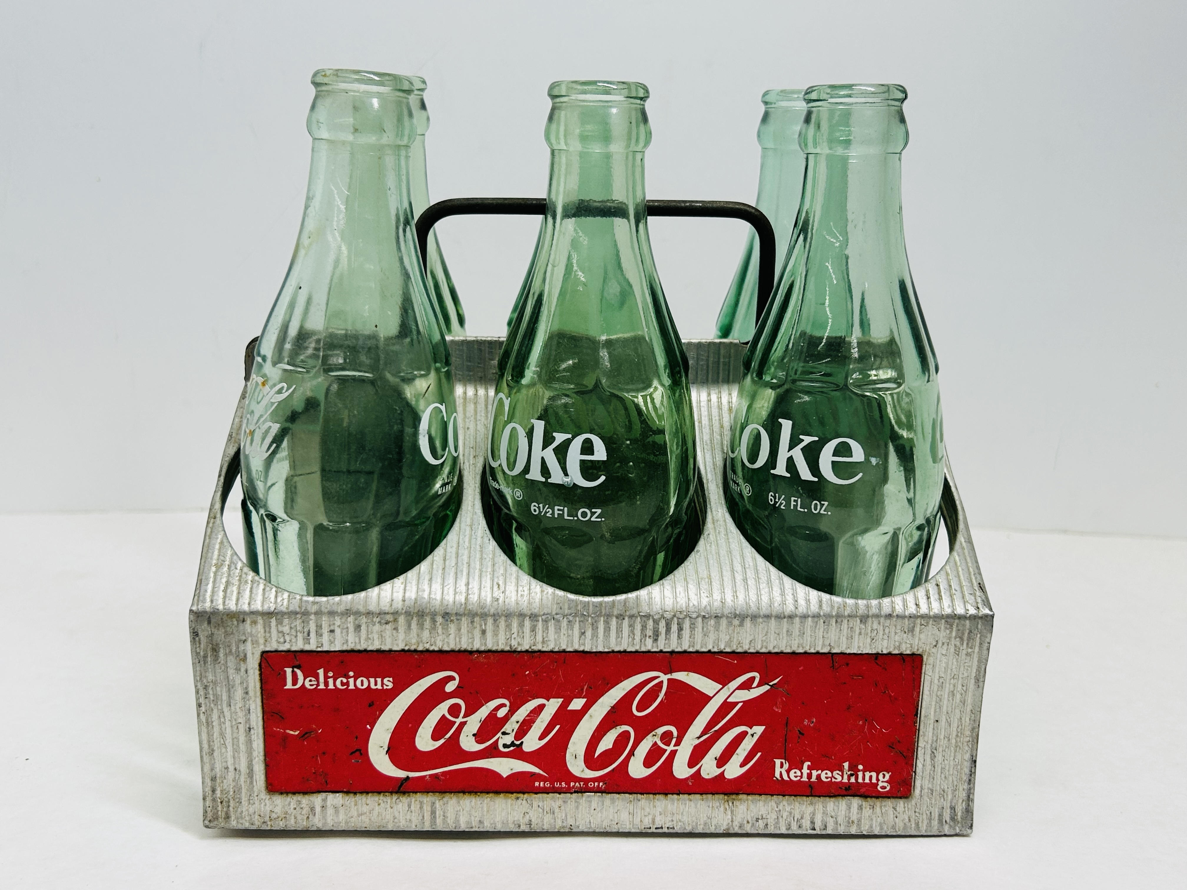 COCA-COLA ALUMINUM CARRIER AND BOTTLES