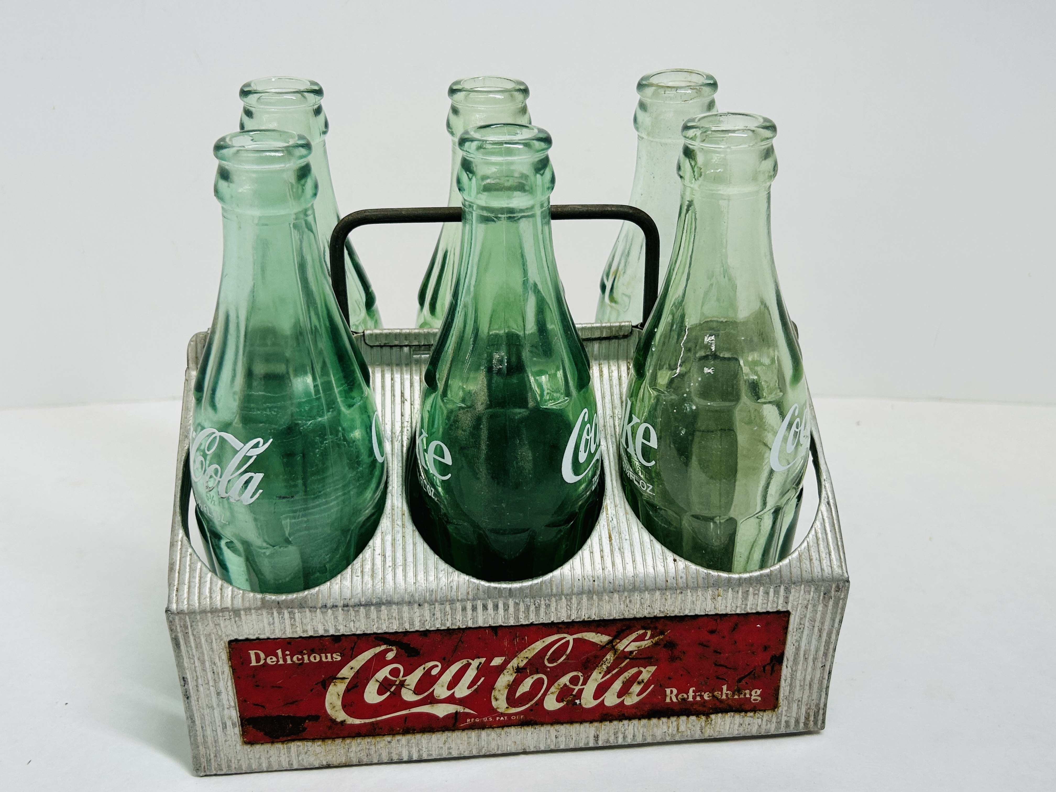 COCA-COLA ALUMINUM CARRIER AND BOTTLES
