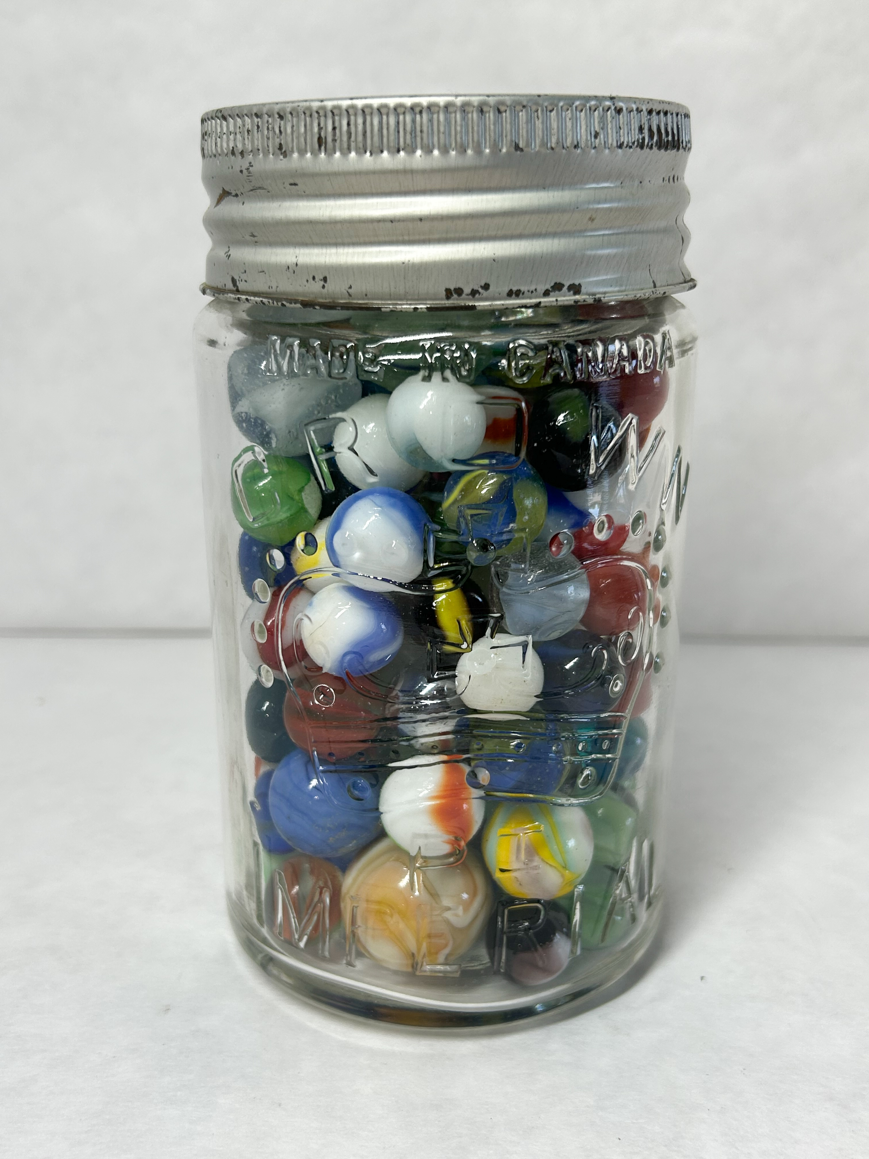 CROWN GLASS JAR AND MARBLES
