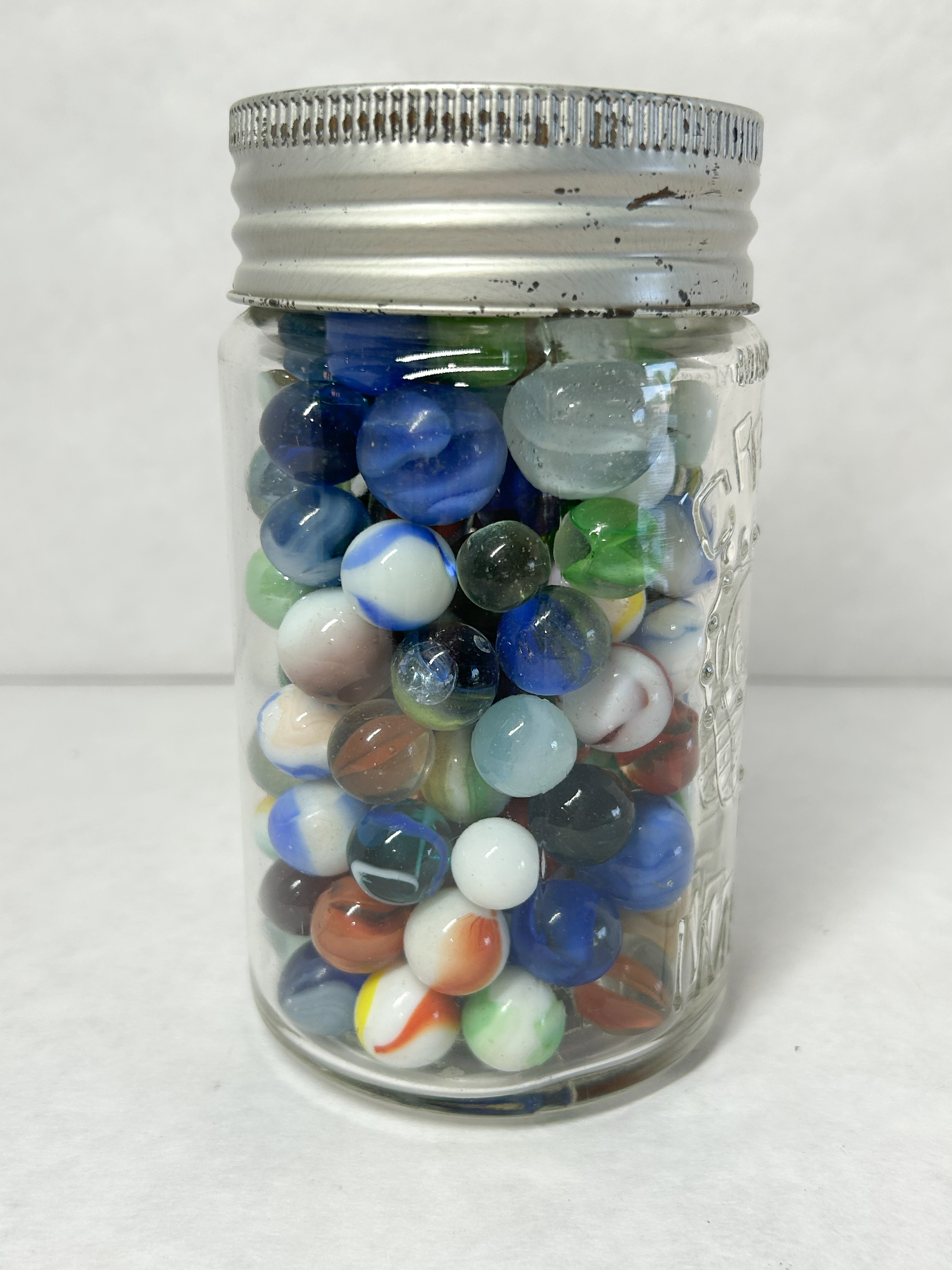 CROWN GLASS JAR AND MARBLES