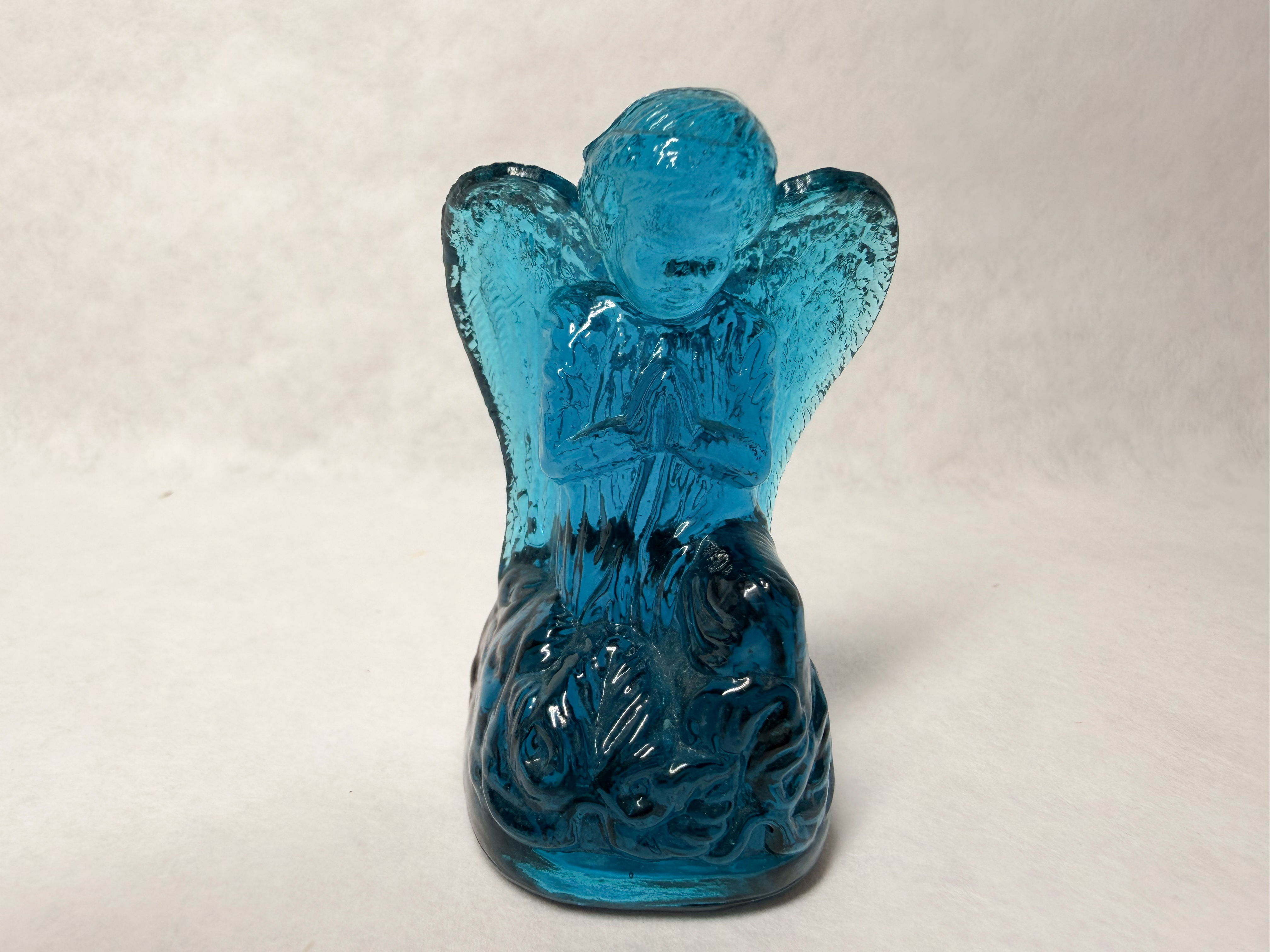 BOYD BLUE GLASS PRAYING ANGEL, LATE 20TH CENTURY