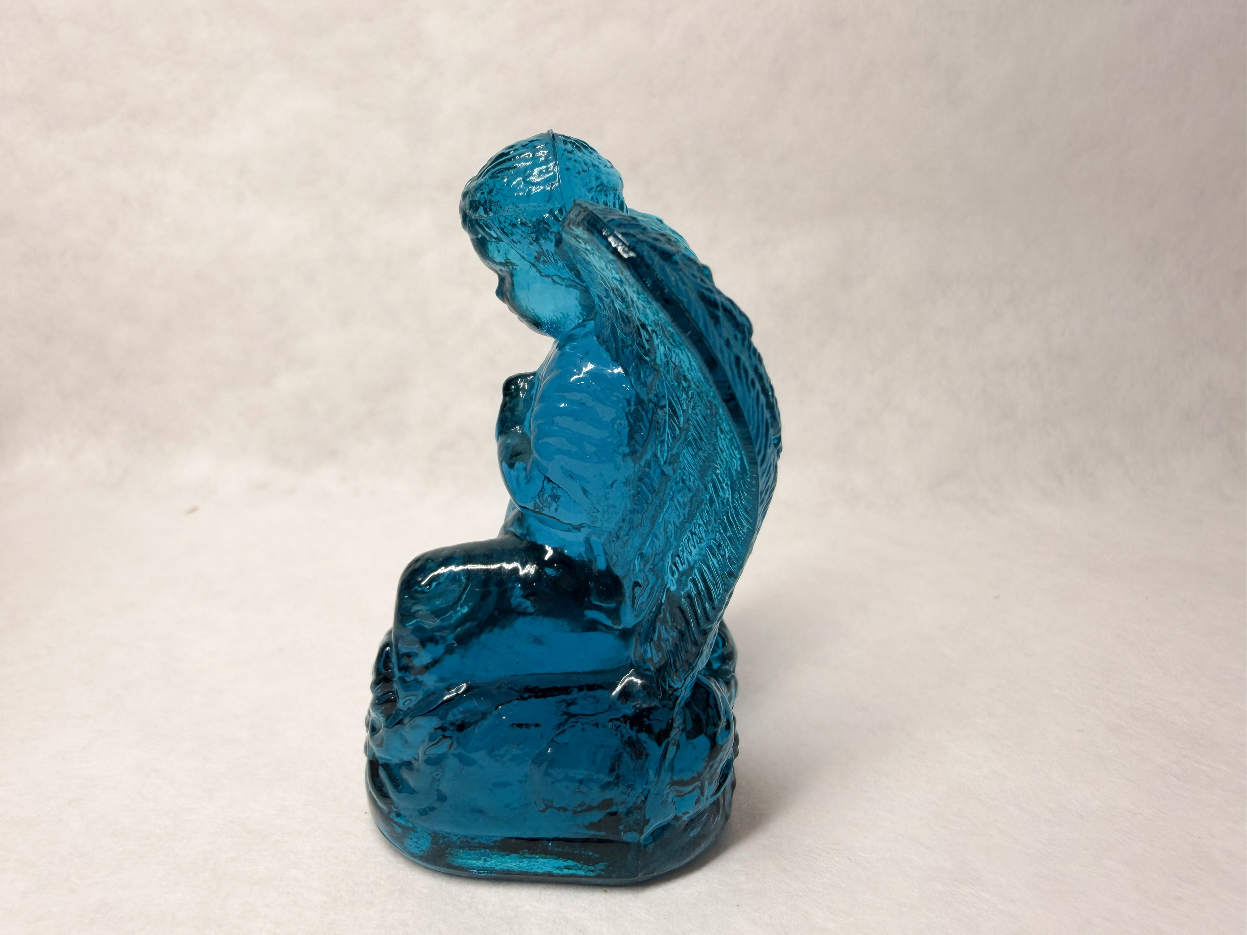 BOYD BLUE GLASS PRAYING ANGEL, LATE 20TH CENTURY