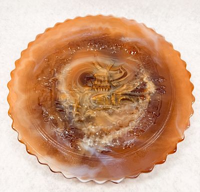 IMPERIAL WINDMILL CARAMEL SLAG GLASS PLATE. A vintage pressed slag glass plate featuring a 