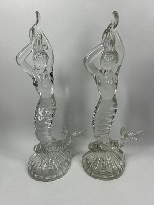 PAIR OF CLEAR GLASS MERMAID FIGURINES. A matched pair of molded clear glass figurines depicting 