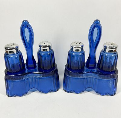 PAIR OF COBALT GLASS CASTER SETS, CIRCA 1930. A pair of cobalt blue glass salt and pepper caster 