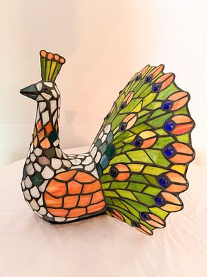 TIFFANY STYLE PEACOCK ACCENT LAMP. glass accent lamp depicting a peacock with a fanned tail. The 