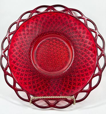 RUBY RED OPENWORK GLASS PLATE. A mid-century pressed glass plate in a saturated ruby red color 
