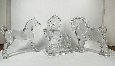 HEISEY HORSE FIGURINES. A trio of clear molded glass figurines featuring distinct equestrian 