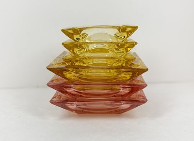 SIX MID-CENTURY PRESSED GLASS ASHTRAYS. A set of six vintage pressed glass ashtrays featuring 