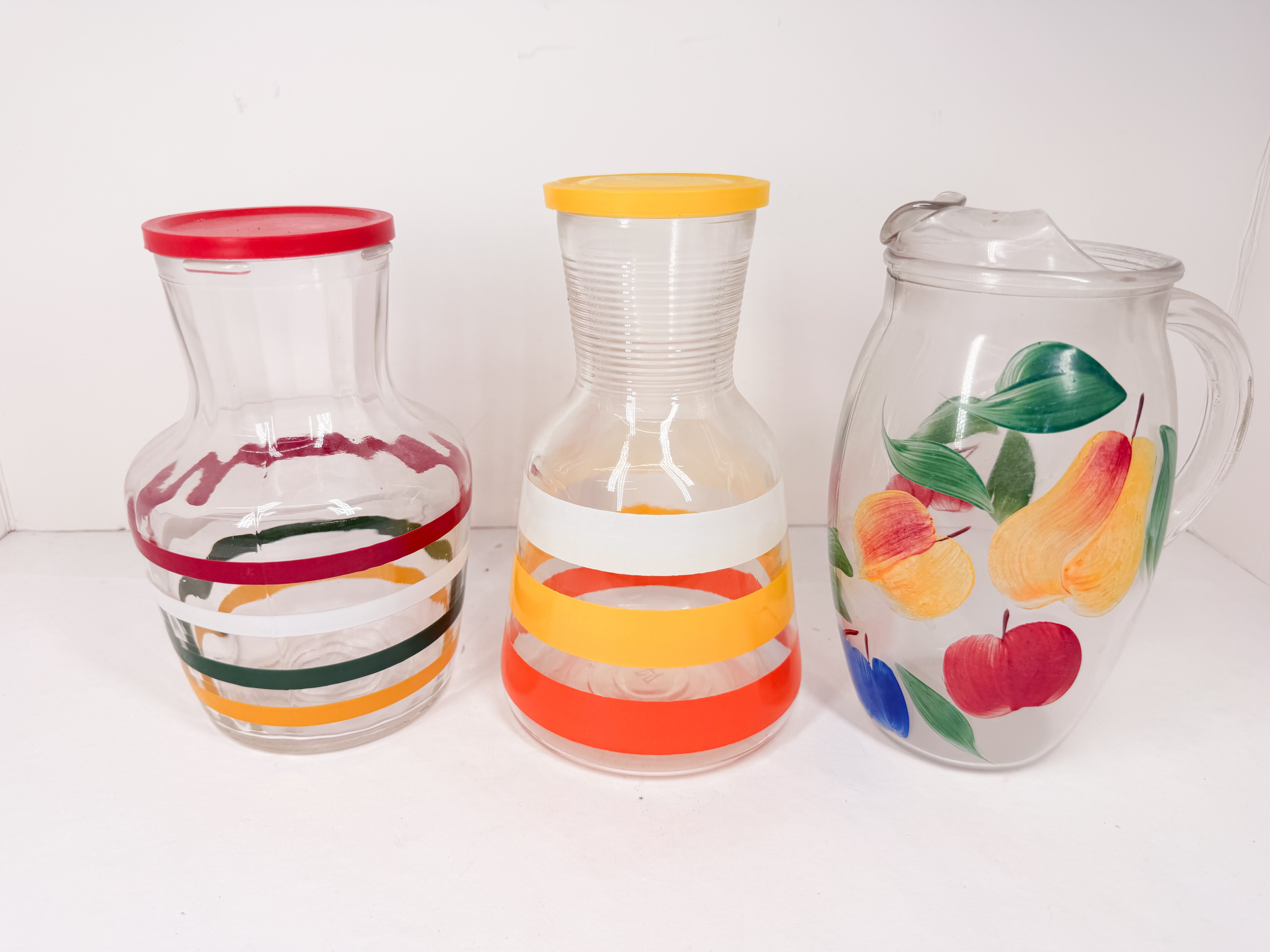 THREE GLASS JUICE CARAFES AND PITCHER