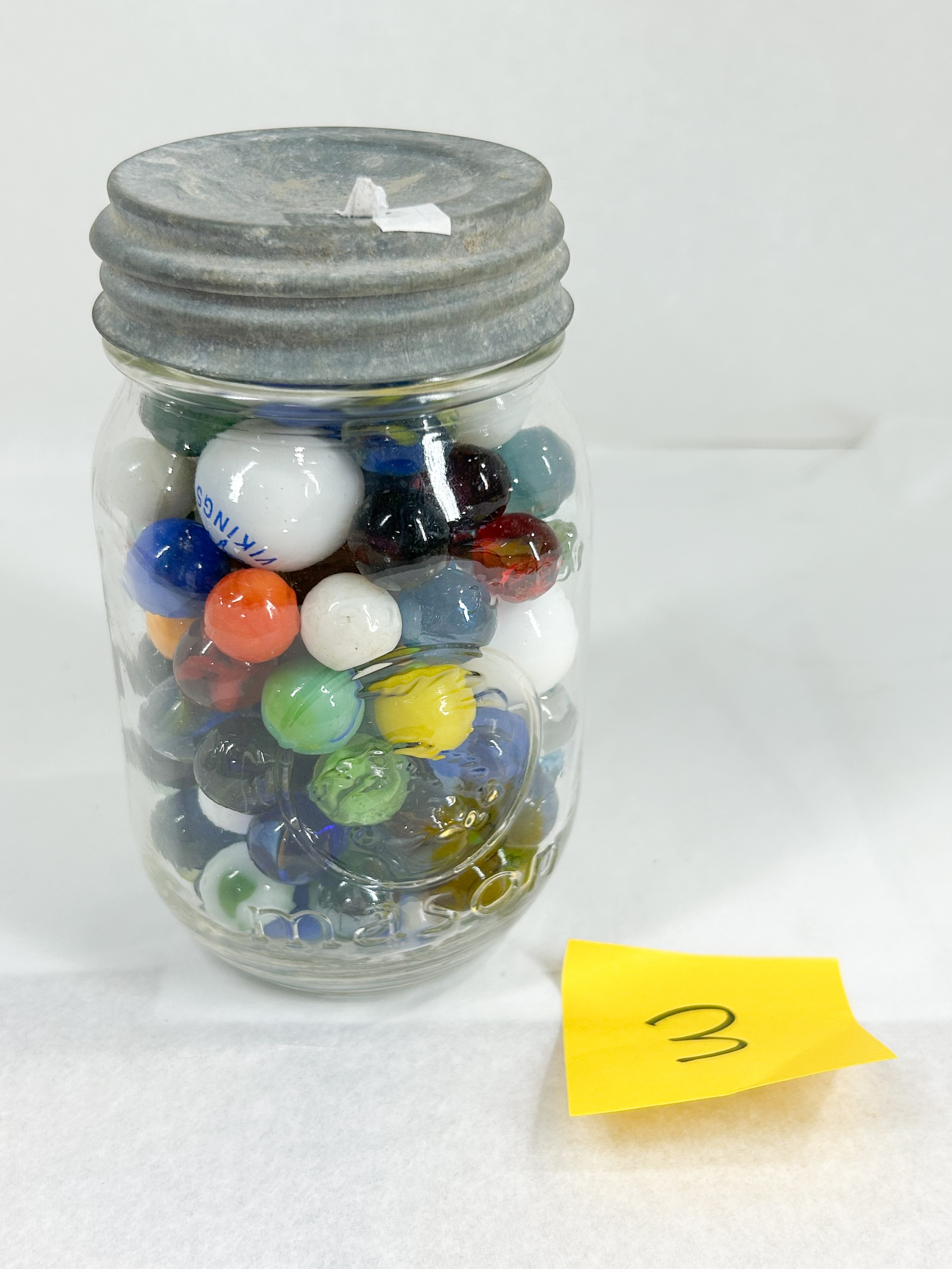 ASSORTED GLASS MARBLES IN MASON JAR