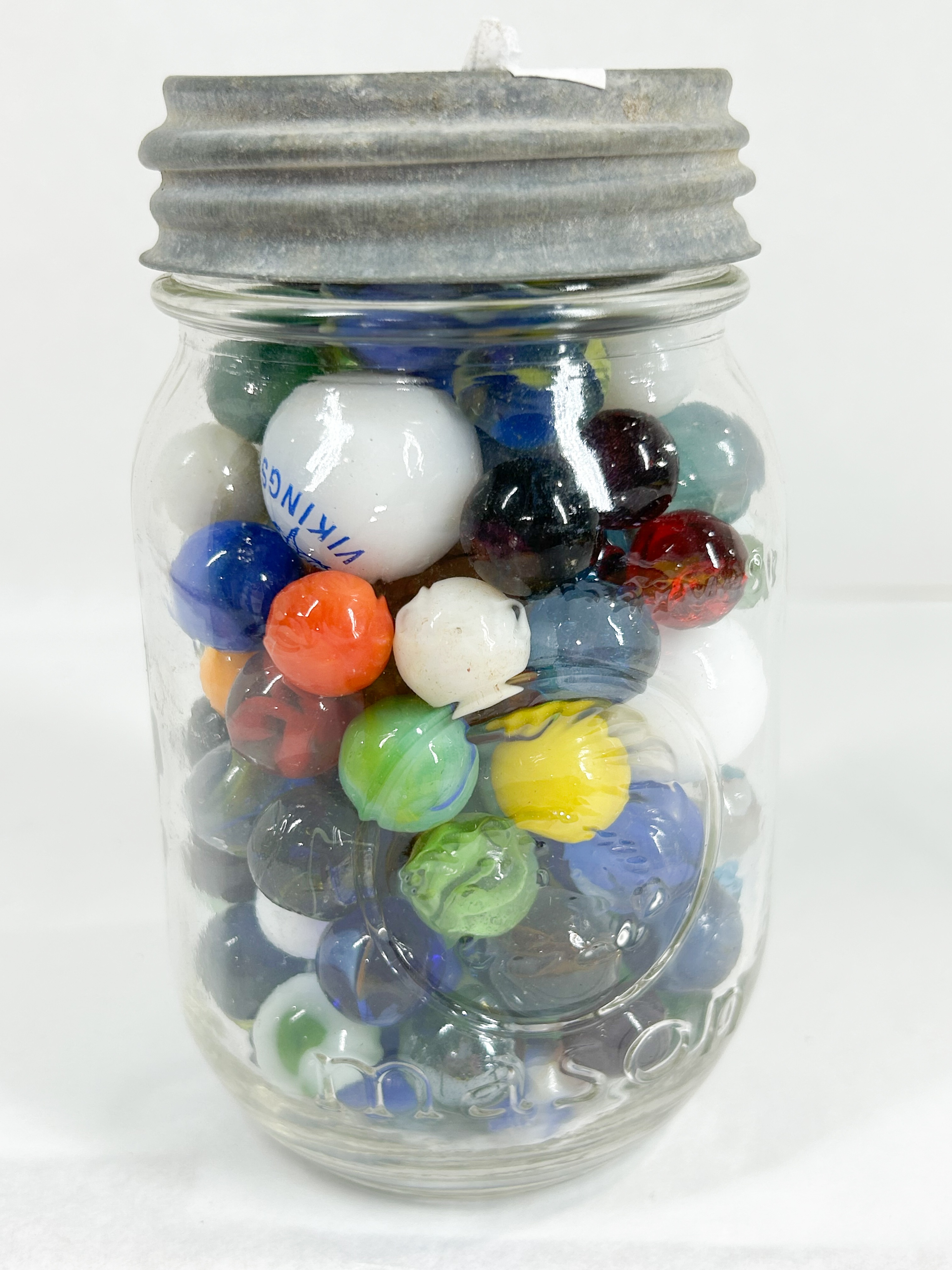 ASSORTED GLASS MARBLES IN MASON JAR
