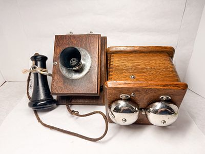 OAK WALL TELEPHONE COMPONENTS, CIRCA 1900. Two antique magneto telephone components constructed 