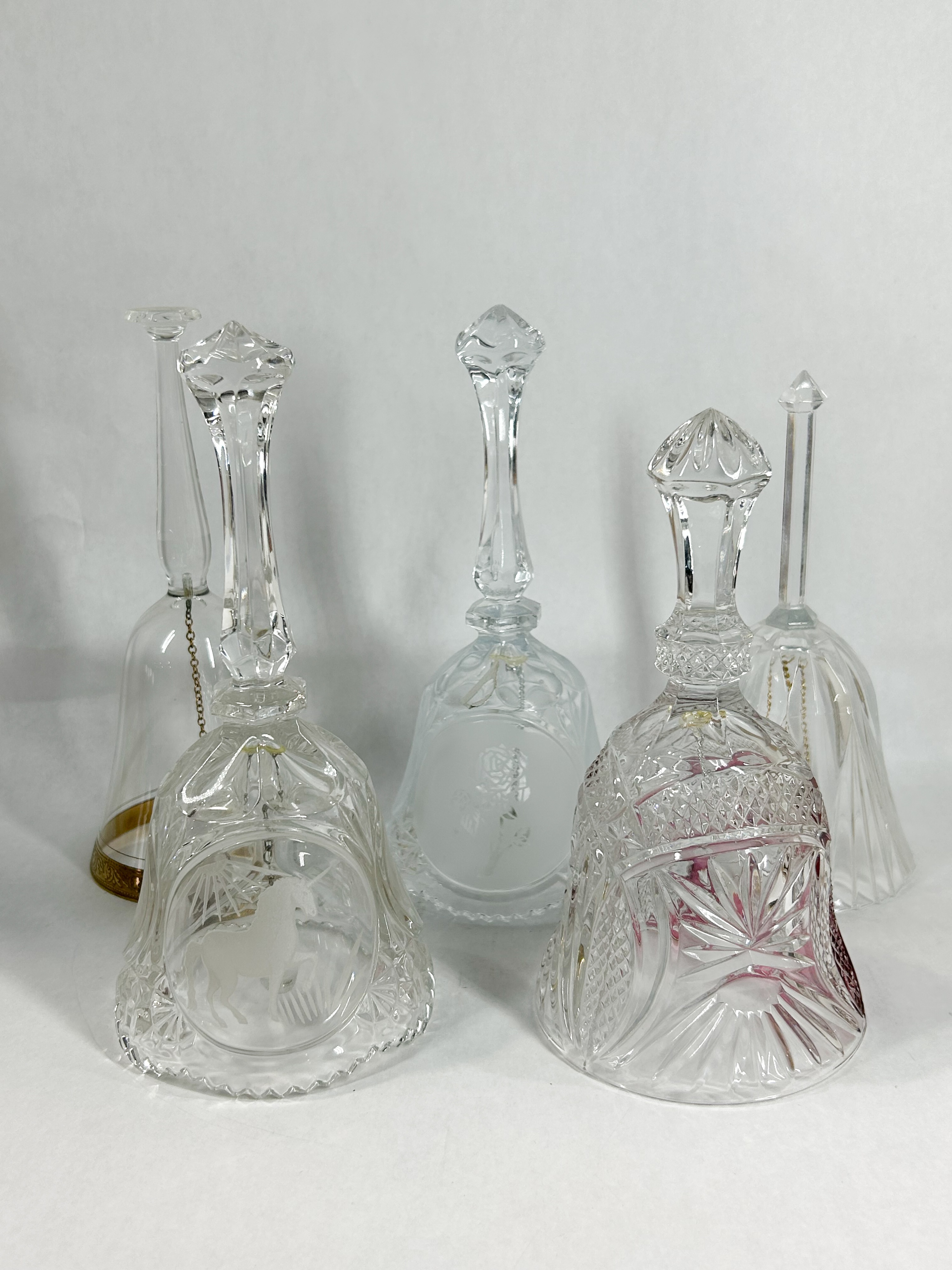 COLLECTION OF FIVE CUT AND ETCHED CRYSTAL HAND BELLS