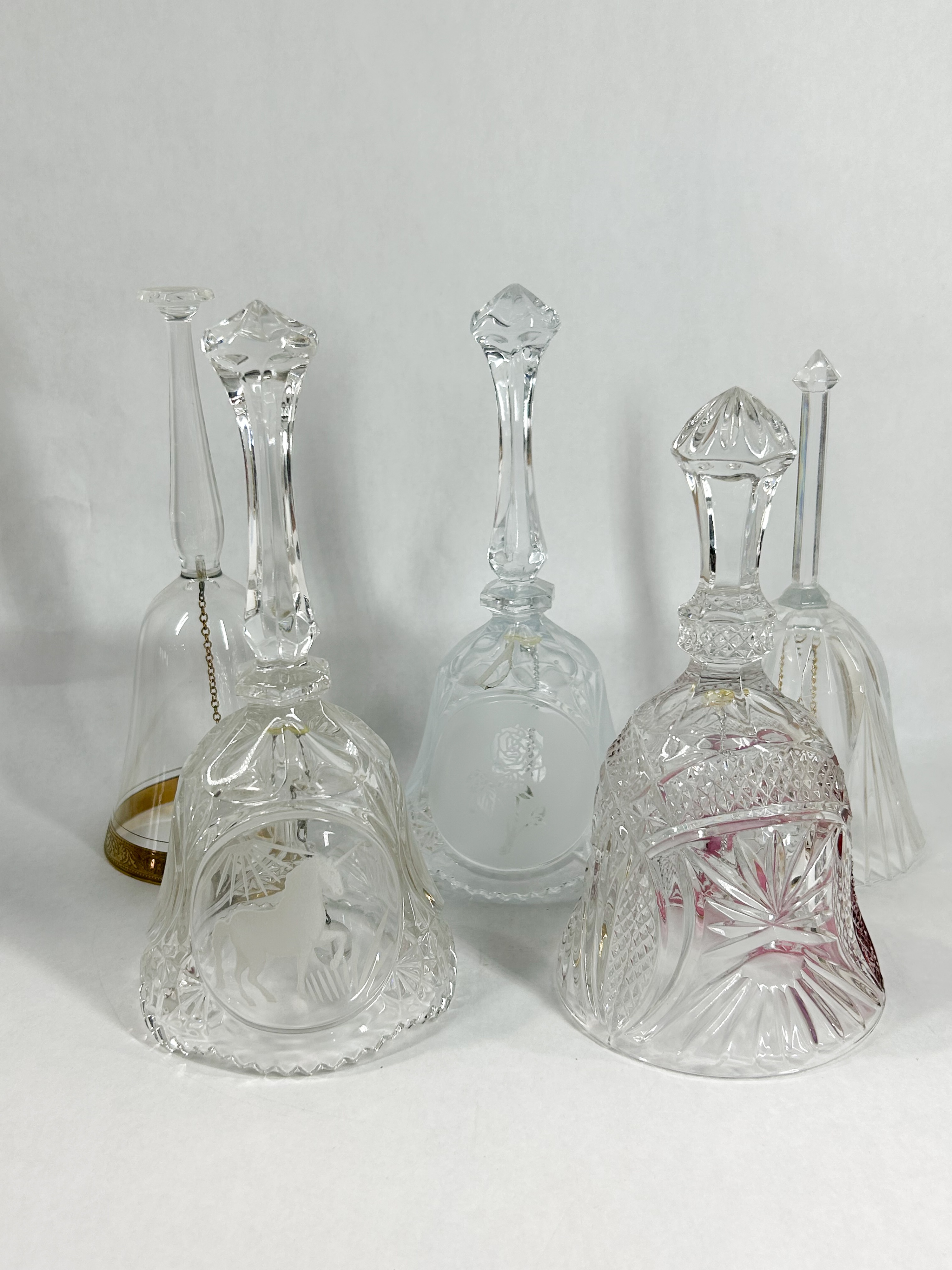 COLLECTION OF FIVE CUT AND ETCHED CRYSTAL HAND BELLS