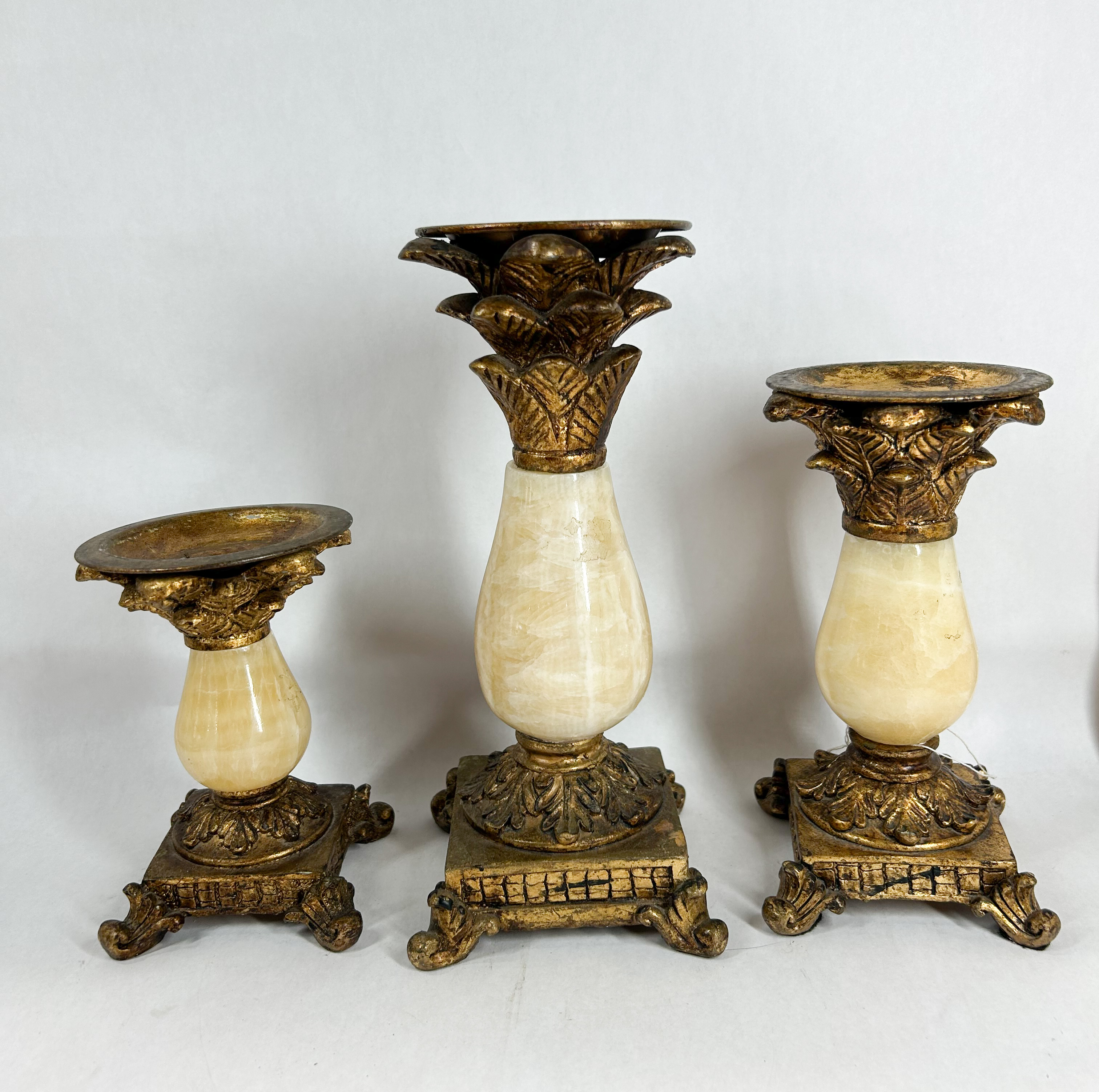GRADUATED SET OF ONYX AND GILT PILLAR CANDLE HOLDERS