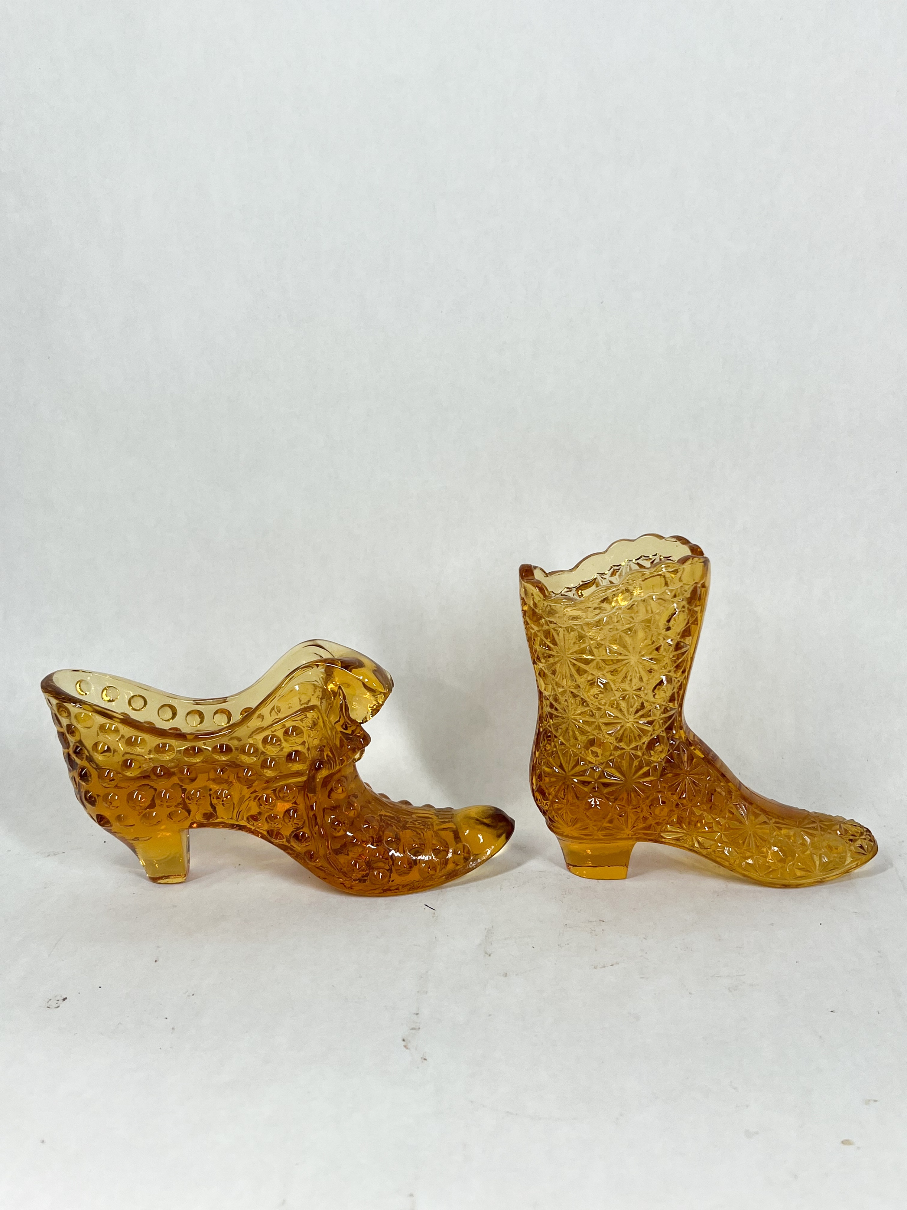 TWO AMBER GLASS SHOES