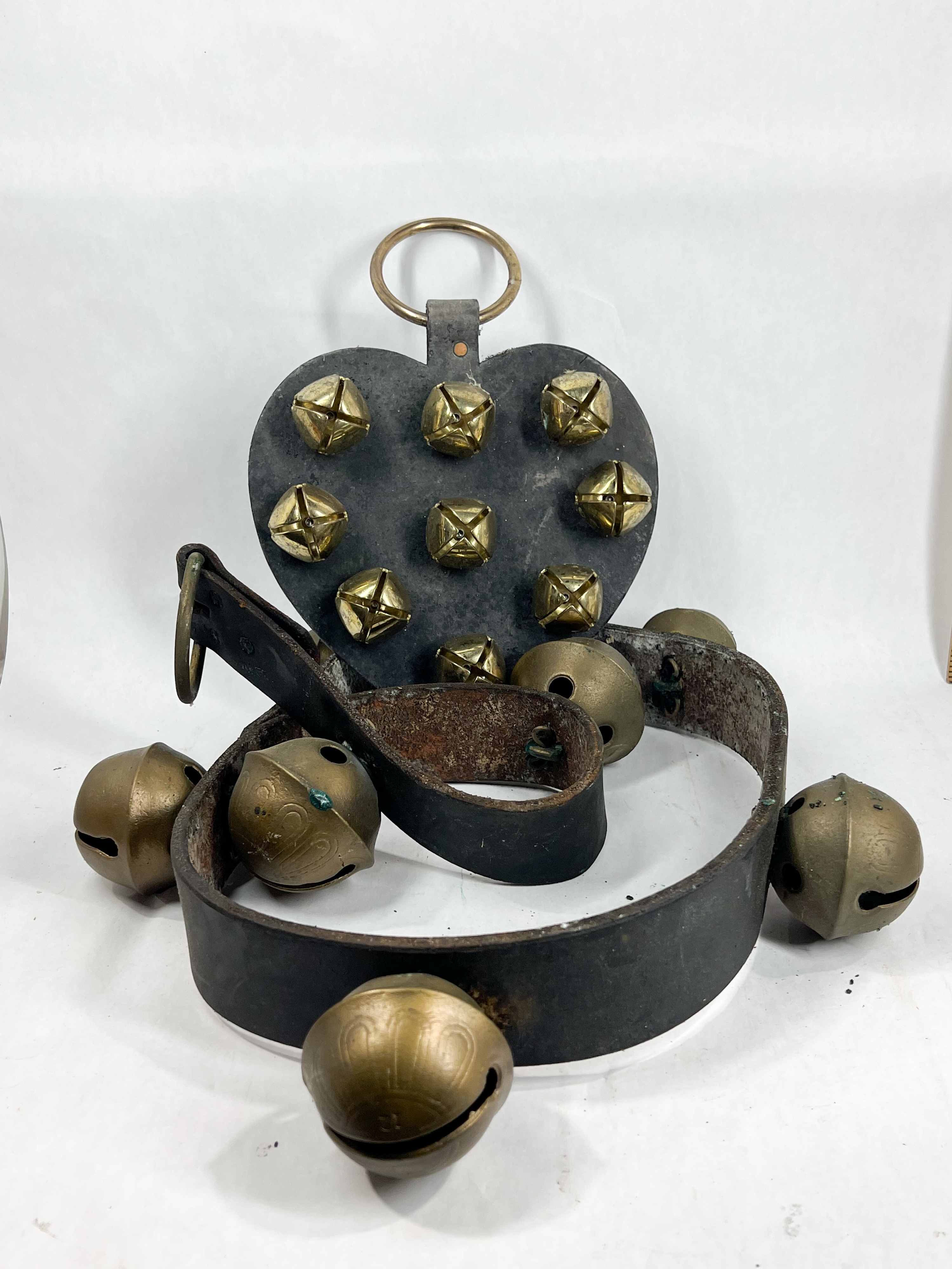 TWO BRASS AND LEATHER SLEIGH BELL HANGERS