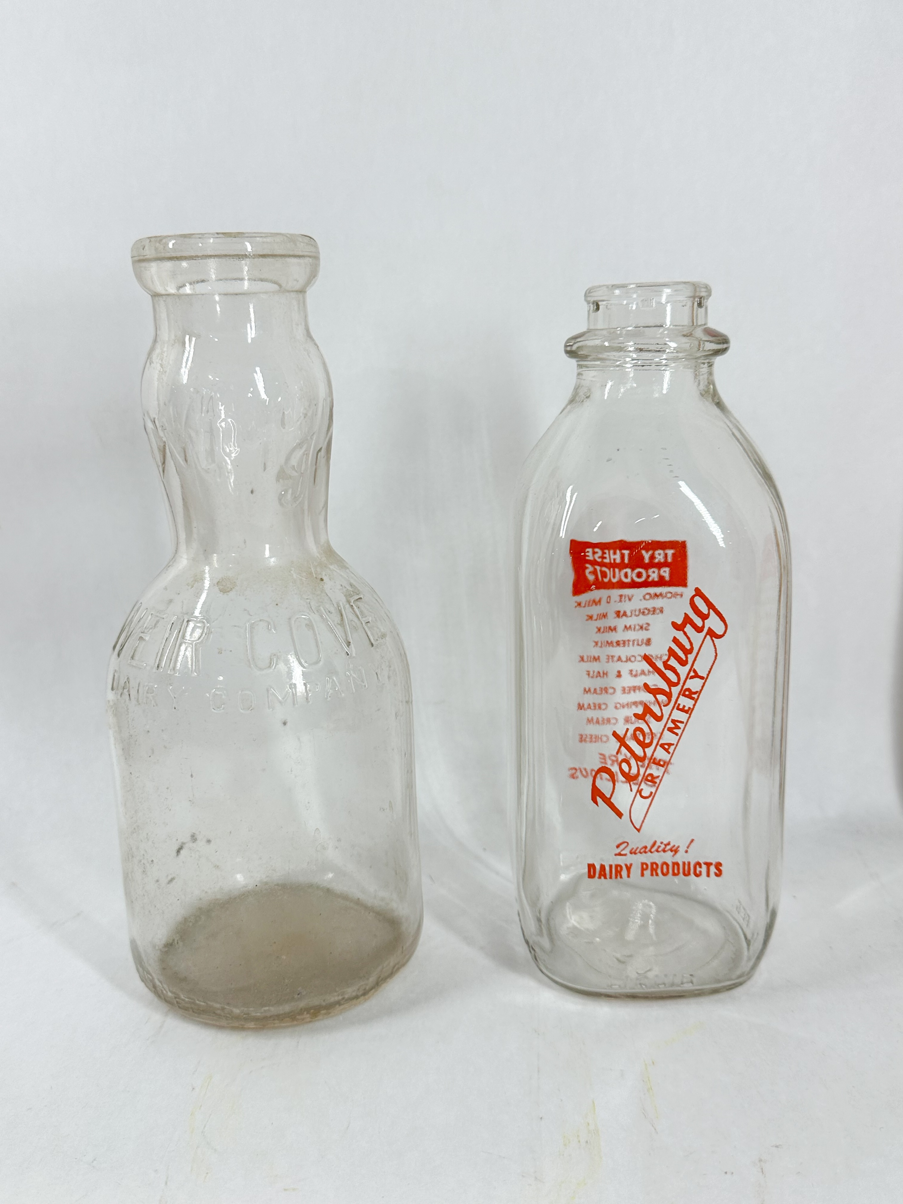 TWO REGIONAL GLASS DAIRY BOTTLES, MID-20th CENTURY