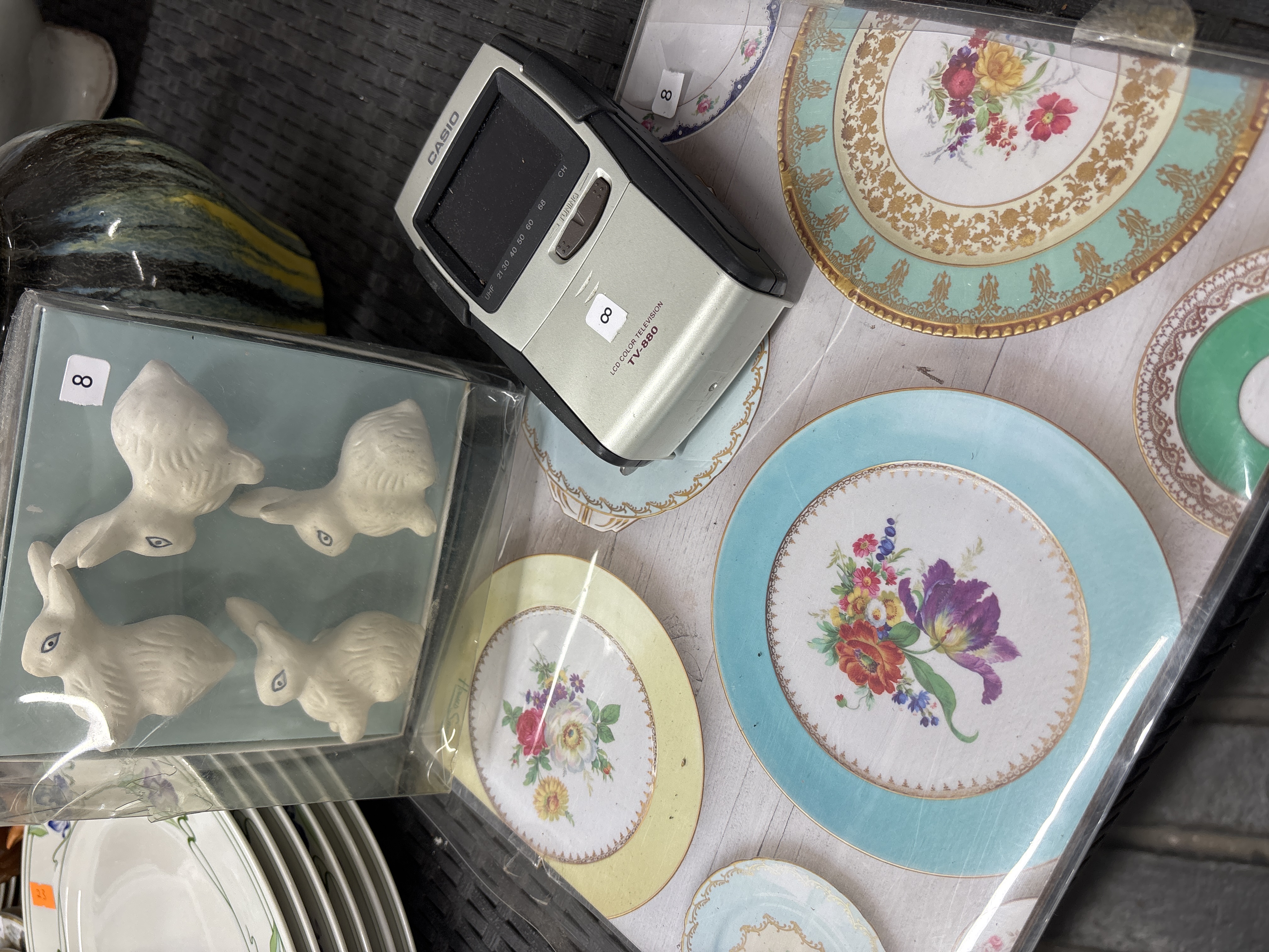 Casio TV-880 Portable Television, Four Ceramic Rabbit Figurines, and an Assortment of Decorative Porcelain Plates